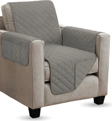 A grey quilted armchair protector is shown on a neutral-colored armchair.