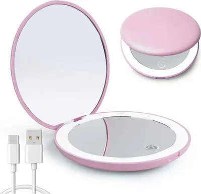 A pink compact mirror with a built-in LED light is shown open and closed, along with a USB charging cable.