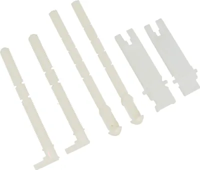 A collection of white plastic plumbing parts arranged diagonally on a white background.