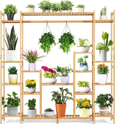 A multi-tiered bamboo plant stand filled with various potted plants.