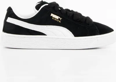 A side view of a black Puma Suede XL sneaker with white accents and laces.