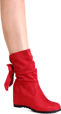A person's leg wearing a red boot.