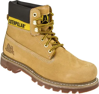 A single tan work boot with yellow laces and black accents.