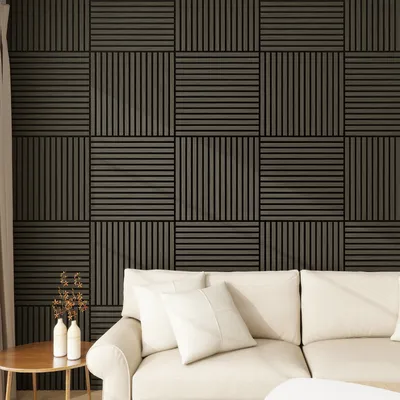 A living room scene with a couch and a wall decorated with acoustic panels.