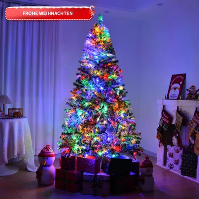 A decorated Christmas tree with lights and presents underneath, in a room with a fireplace and stockings.