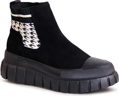 A single black boot with a platform sole and a houndstooth pattern on the side.