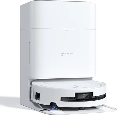 A white robot vacuum cleaner docked in its charging station.