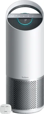 A white and silver air purifier with a digital display and a separate sensor unit.
