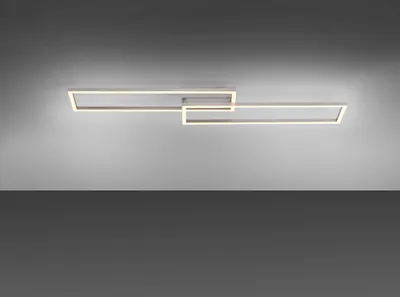 A modern, minimalist LED ceiling light with two interlocking rectangular frames, mounted on a gray ceiling.