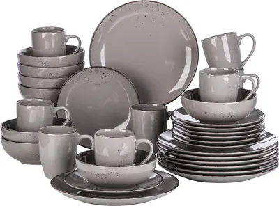 A collection of grey ceramic dishes and mugs are neatly arranged.