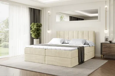 A bedroom scene with a bed, nightstand, and plant.