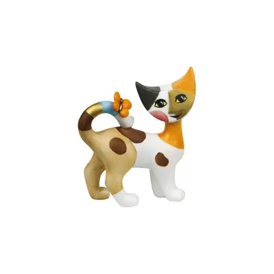A ceramic figurine of a calico cat with a decorative tail.