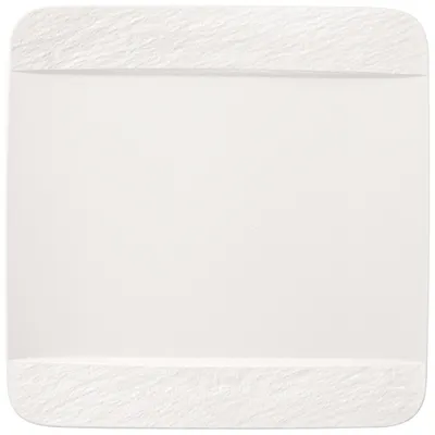 A white plate with textured edges on a white background.
