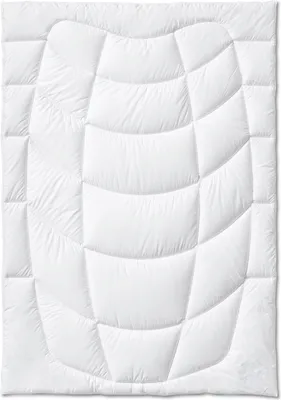 A white quilted comforter laid flat on a white background.