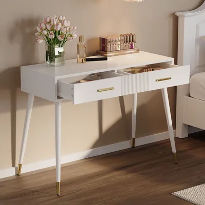 A white vanity table with two drawers, one open, displaying makeup and flowers.