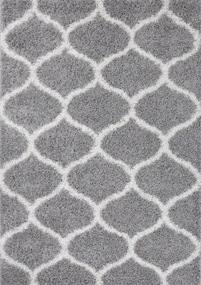 A close-up view of a gray rug with a white geometric pattern.