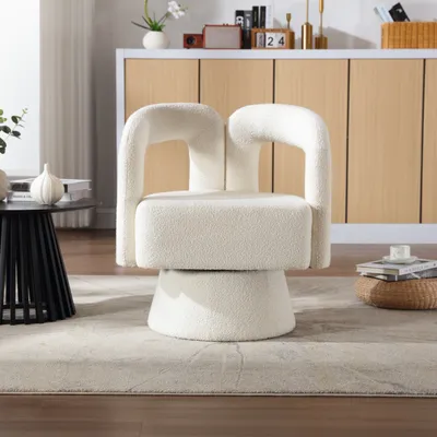 A bouclé armchair is placed on a rug in a living room setting.