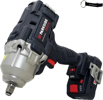 A cordless impact wrench with a battery pack and a keychain.