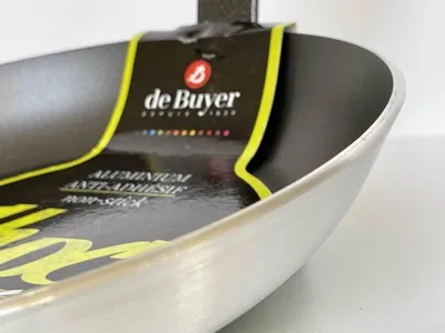 A close-up view of the inside of a De Buyer frying pan, showing the brand's label.