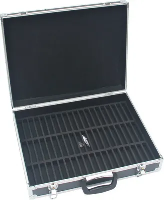 An open black storage case with foam inserts for holding cassette tapes.