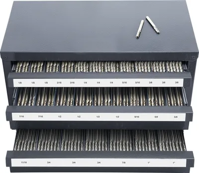 A gray metal organizer cabinet with three drawers filled with drill bits. Two drill bits are placed on top of the cabinet.