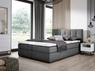 A bedroom setting with a bed, nightstand, and dresser.