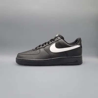 A single black Nike Air Force 1 sneaker with a white swoosh logo is shown against a plain gray background.