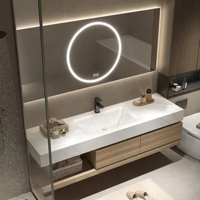 A modern bathroom vanity with a sink, faucet, mirror, and storage.