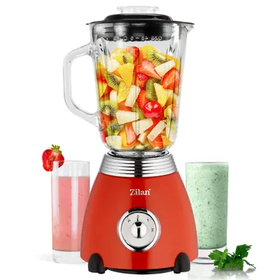 A red Zilan retro stand mixer filled with chopped fruit, with two glasses of smoothies next to it.