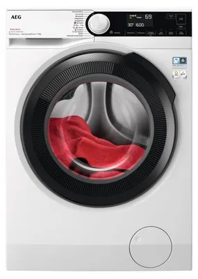 A front view of a white AEG washing machine with a red towel inside the drum.