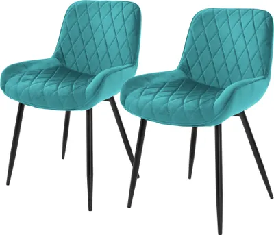 Two teal velvet dining chairs with diamond tufting and black metal legs are shown against a white background.