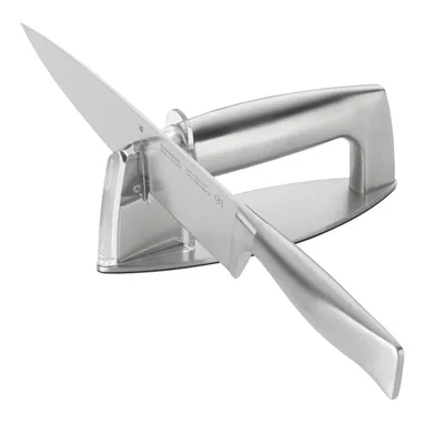 A stainless steel knife sharpener with a knife inserted.