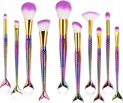 A collection of 10 makeup brushes with mermaid-tail shaped handles and rainbow-colored bristles.