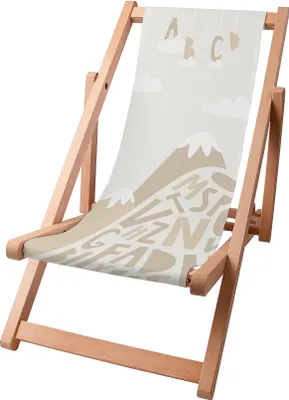 A wooden deck chair with a printed fabric seat featuring mountains and letters.