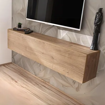 A modern, minimalist living room with a floating wooden TV stand mounted on a wall with a floral wallpaper pattern.