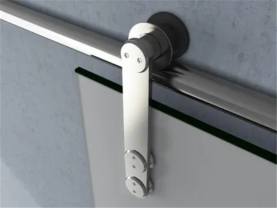 A close-up view of a sliding glass door hardware system mounted on a wall.