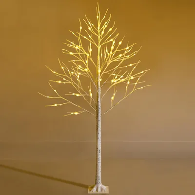 A decorative LED tree with warm white lights against a plain background.