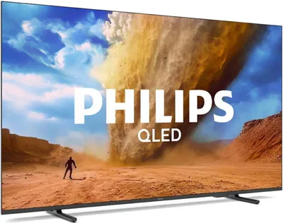 A Philips QLED TV displaying a dramatic desert scene with a large dust devil and a lone figure in the foreground.