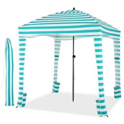 A striped beach tent with its carrying bag shown next to it, set against a white background.