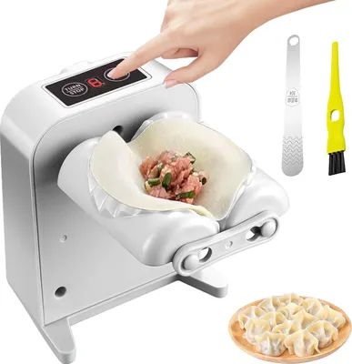A person's hand is pressing a button on an automatic dumpling maker, which is filled with ingredients and a wrapper. Accessories and finished dumplings are also visible.