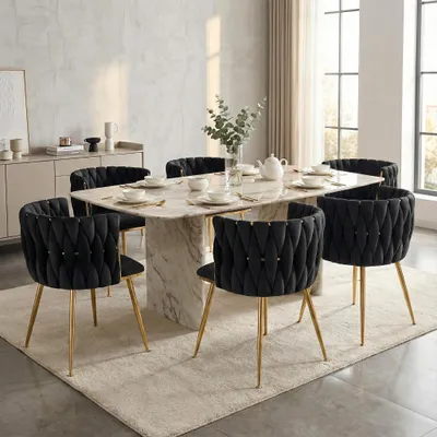 A dining room scene with a marble-topped table and six black velvet chairs with gold legs.