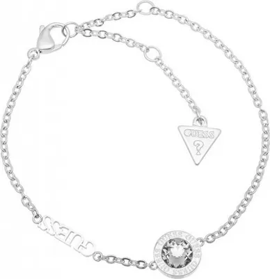 A silver-colored bracelet with a clear gemstone and a Guess logo charm.