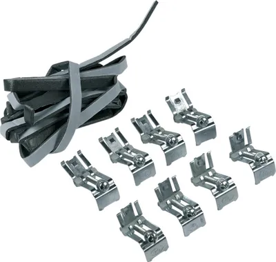 A pile of gray and black rubber strips tied together with gray straps, and a set of shiny metal clips arranged in a cluster to the right.