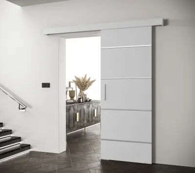 A modern interior hallway with a white sliding door and a wooden cabinet with decorative items.