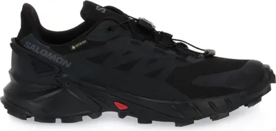 A black Salomon trail running shoe is shown from the side against a white background.