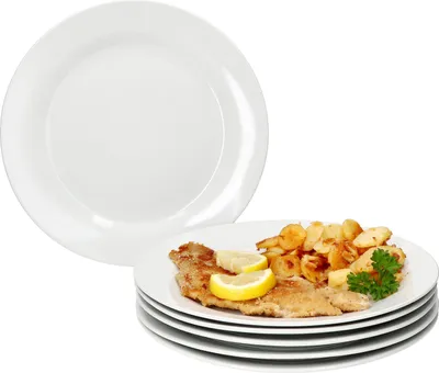 A stack of white plates, with one plate on top showing a meal.