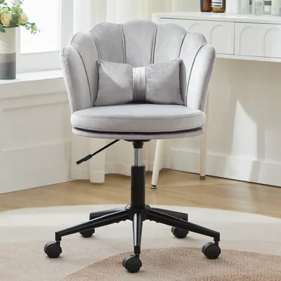 A gray velvet office chair with a petal-shaped backrest and a small decorative pillow is shown in a well-lit room.