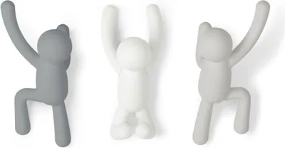 Three wall hooks shaped like climbing figures, in different shades of gray and white.