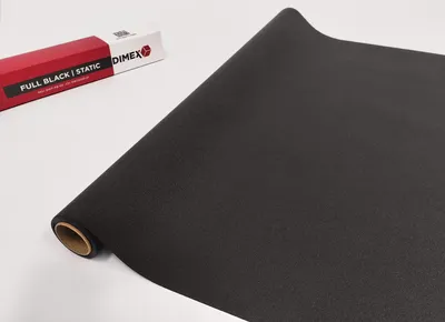 A roll of black static cling window film is shown diagonally across a white surface, with its packaging box in the background.