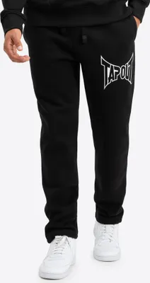 A person wearing black sweatpants with a white logo.